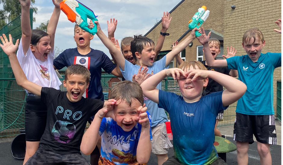 Children having fun during wet wednesday activities during the summer holidays