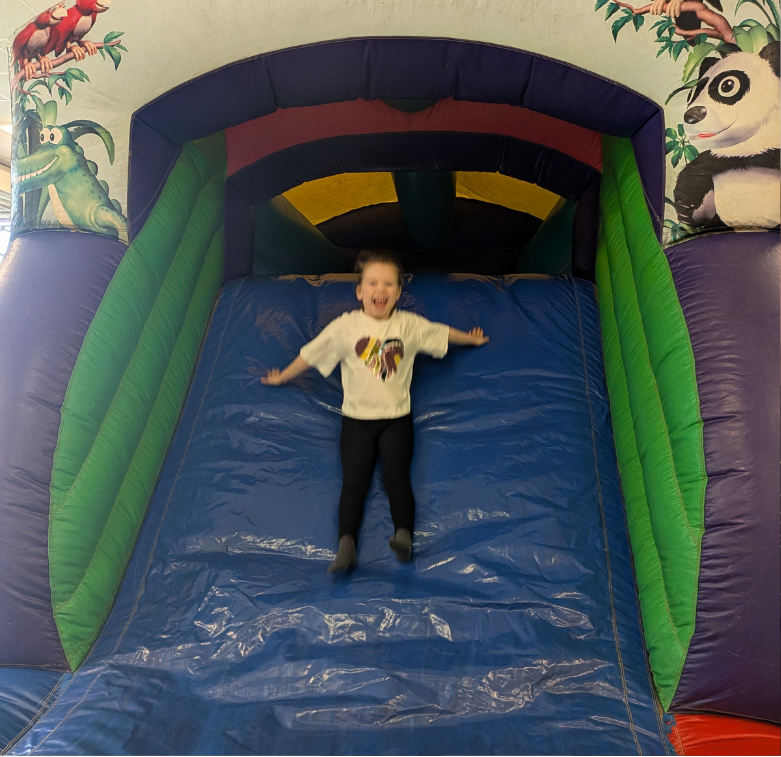 Child sliding down inflatables at LSC holiday club