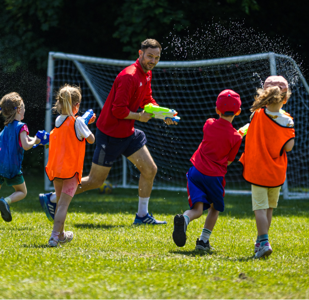 Children and site lead having fun during wet wednesday activity at LSC holiday club