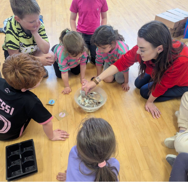 group of children around site lead participating in animal encounters