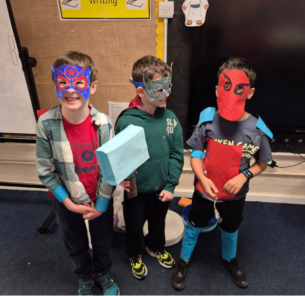 Three children in fancy dress for superhero day