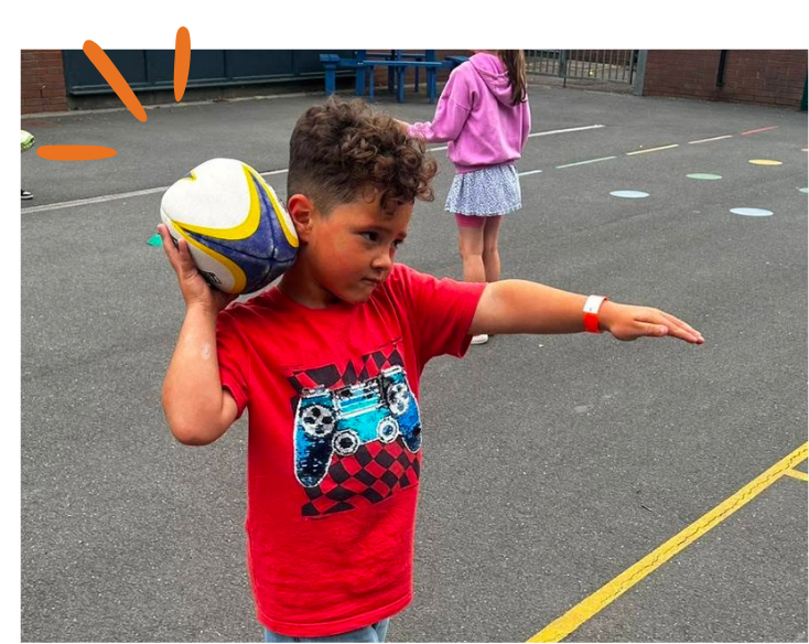 Children smiling, holding maracas they made during 'Creative' programme at LSC summer holiday club.