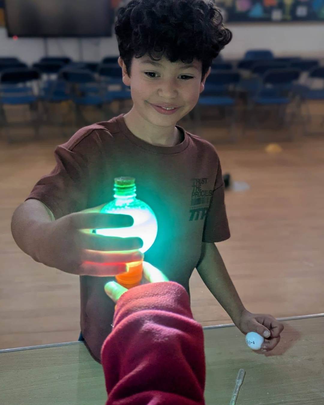 Child holding a glowing homemade Halloween potion