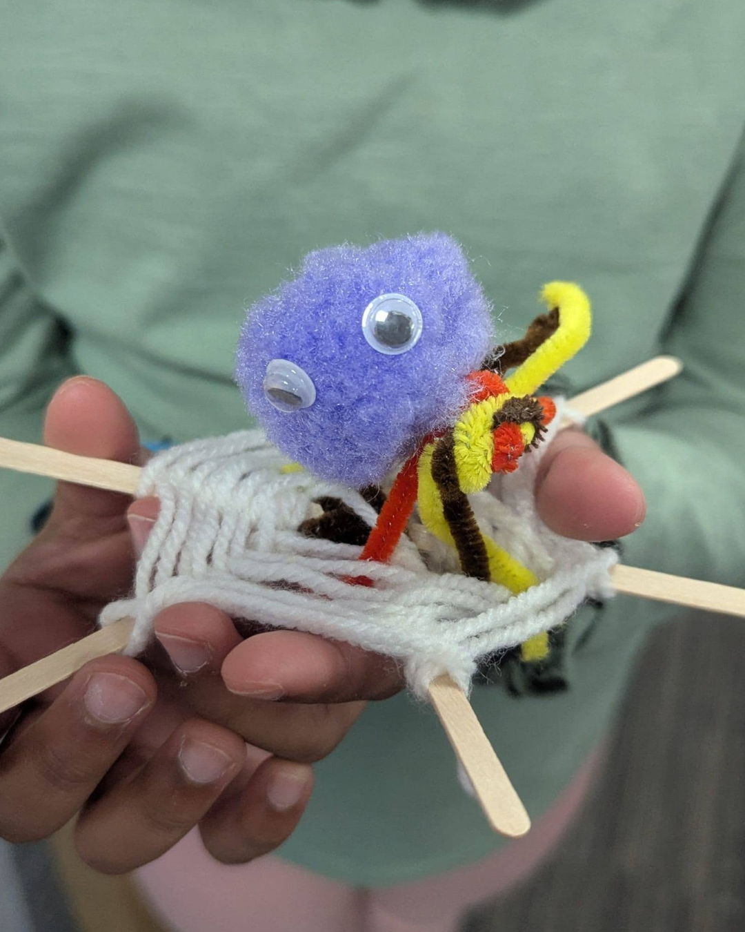 Children's Halloween craft activity featuring handmade spider webs