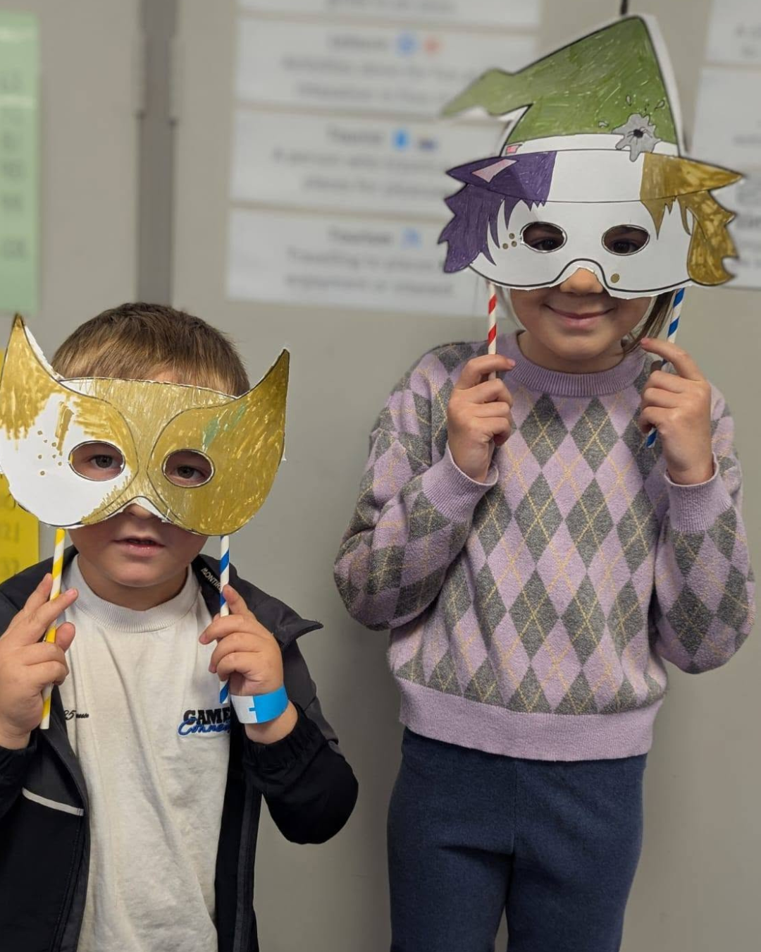 Two children showing off their Halloween masks